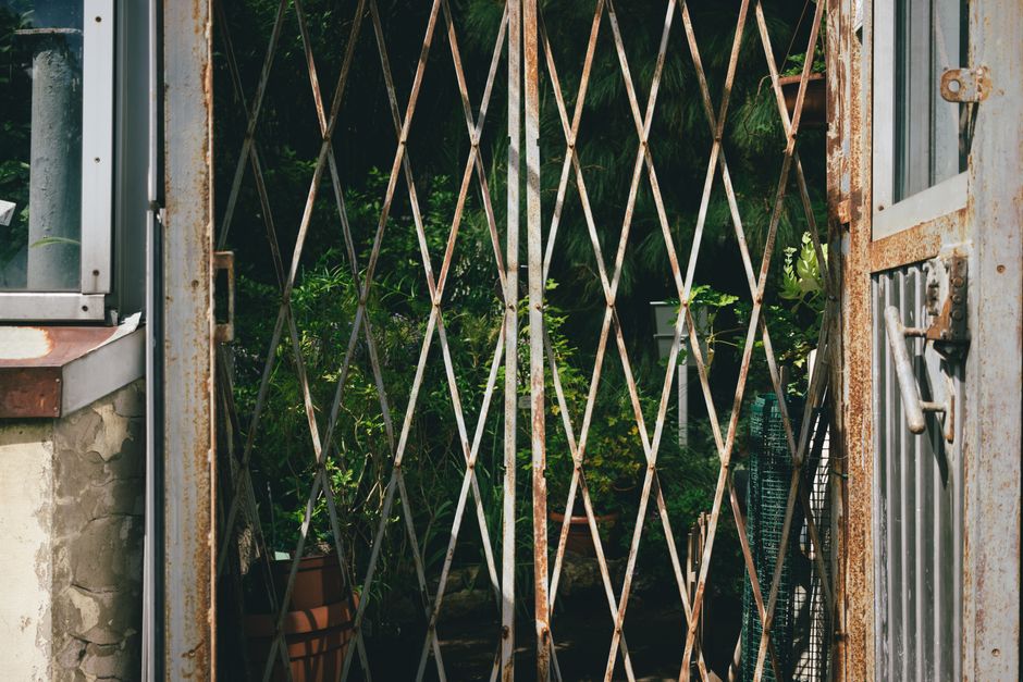 A close-up view of a brick wall with a metal street sign reading 'LOWER TERRACE NW3' attached to it. The bricks are dark red with a rough texture, and the sign features white lettering on a green back
